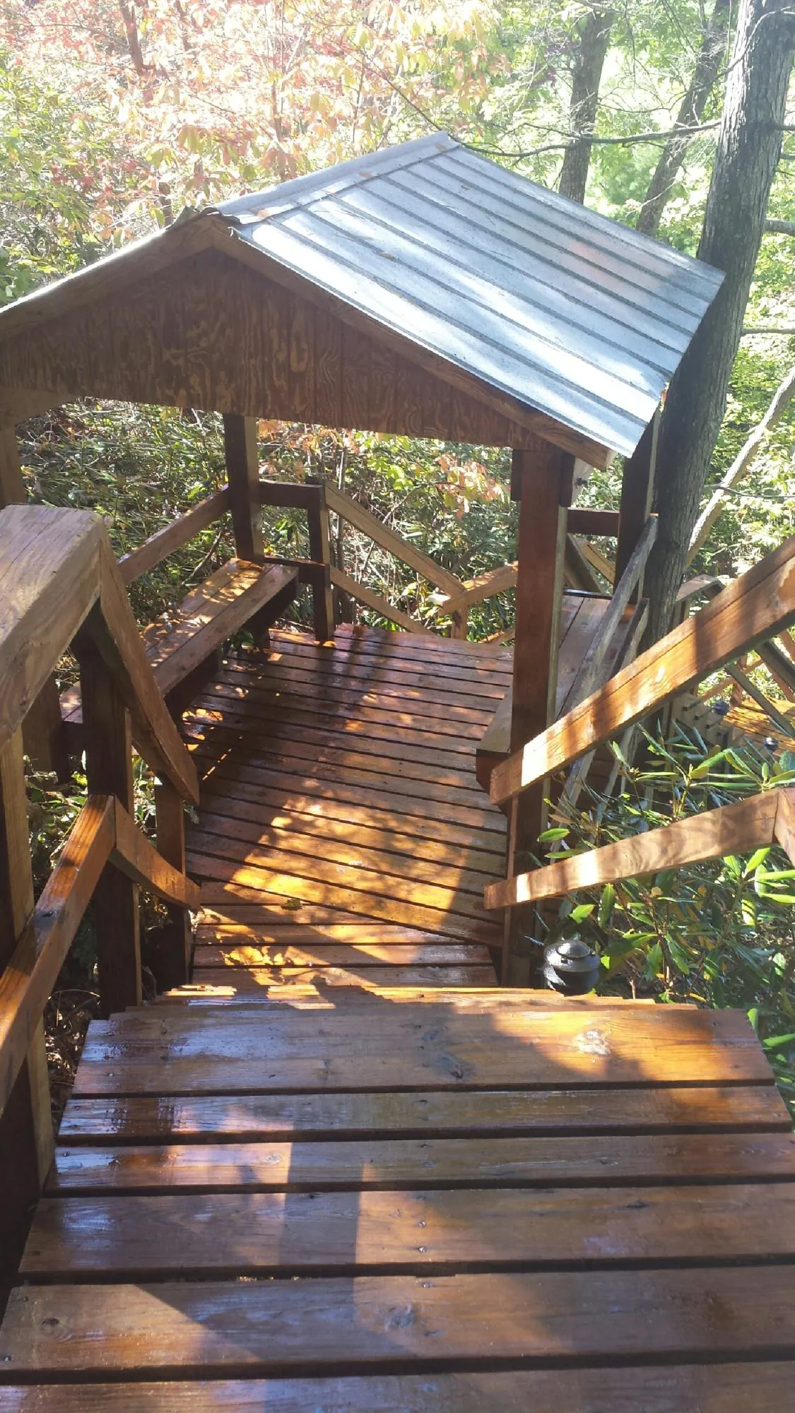 Freshly stained wood walkway and covered shelter with a metal roof in Rochelle